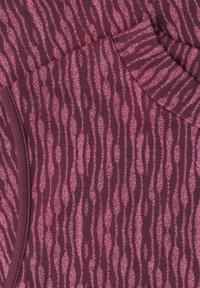 Close-up of maroon and pink knit fabric with wavy vertical stripe pattern and ribbed collar detail.