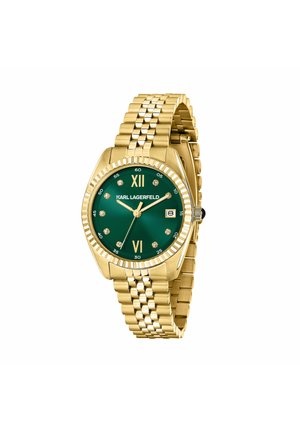 Guldmetallenklet ur med grøn urskive, krystal timeindikatorer, romertal ved 12 og 6, datovindue og "KARL LAGERFELD" logo.