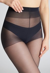 Collants noirs tailles hautes avec une texture transparente, une taille opaque, des panneaux lisses et une coupe ajustée pour le confort et le maintien.