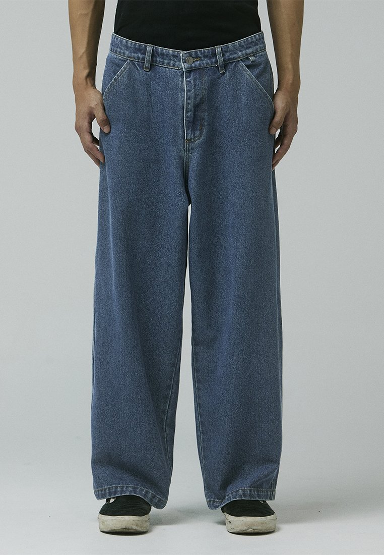 Blue denim wide-leg jeans with a high waist, featuring five pockets, contrasting stitching, and a button-fly closure.