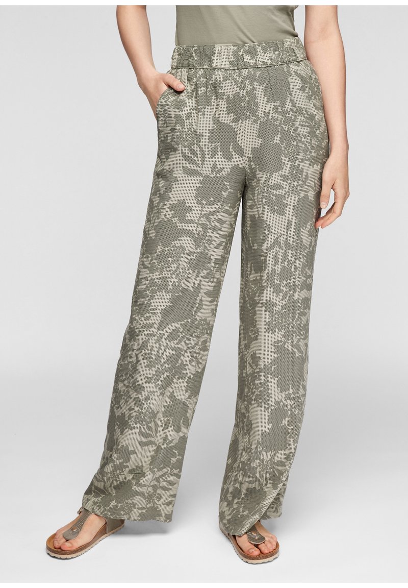 Pantalons évasés en vert olive légèrement atténué avec un motif floral. Fabriqués en tissu doux, ils disposent d'une taille élastique et de poches latérales.