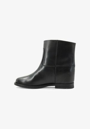 Stivale alla caviglia in pelle nera con una finitura liscia, punta rotonda e tacco basso. Presenta un pannello elastico laterale e dettagli di cucitura minimi.