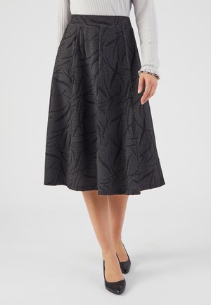 Jupe noire longueur genou avec un motif texturé en feuilles. Fabriquée en tissu tissé, elle présente un design plissé et une taille ajustée.