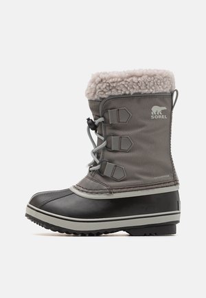 Gray waterproof winter boot with a faux fur collar, rubber lower, and lace-up closure. Features three accent straps and a textured sole.