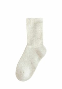 Calzino lavorato a maglia in beige chiaro con righe verticali, dotato di punta e tallone rinforzati, realizzato in un materiale morbido e testurizzato.