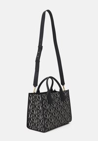 Czarna i szara torebka z logo, z podwójnymi uchwytami i regulowanym paskiem, o stukturze i teksturowanym materiale.