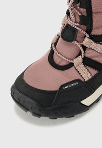 Zapatilla outdoor Amphibiox con parte superior de textil rosa, suela de goma negra y un sistema de cordones prominente para un ajuste seguro. Acabado texturizado.