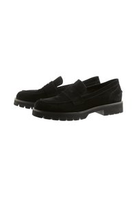 Black suede loafers with a thick, textured rubber sole, featuring a wide strap across the instep and subtle stitching details.
