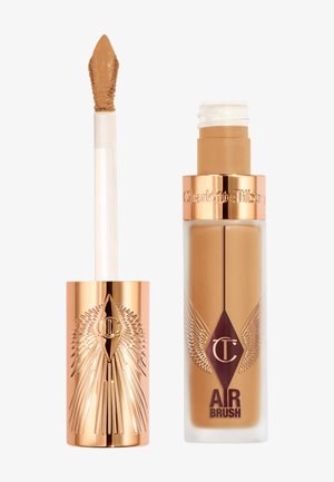 Liquid foundation with a gold and clear bottle, featuring a pointed applicator, engraved design, and "AIR BRUSH" label in purple.