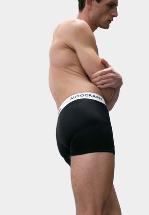 Boxer shorts en coton noir avec une taille blanche portant le texte "AUTOGRAPH". Texture lisse, design ajusté, vu de côté.