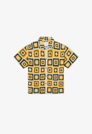 Kurzärmeliges Hemd mit Knöpfen und einem gehäkelten Muster aus grünen, gelben und weißen quadratischen Motiven, die in einem Raster angeordnet sind.