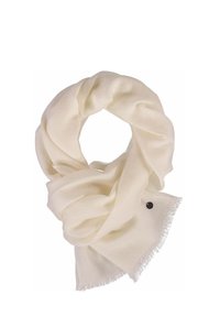 Écharpe crème en tissu doux, avec des bords à franges et un petit accent décoratif sous la forme d'un bouton circulaire foncé.