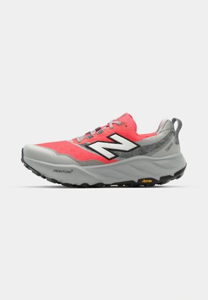 Trail running shoe with a gray and pink upper, featuring a textured mesh design, a thick foam midsole, and a rugged black outsole.
