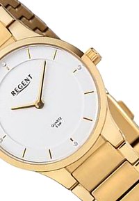 Montre en quartz dorée avec un cadran blanc, des index horaires minimalistes et un bracelet à maillons. Présente une couronne sur le côté.