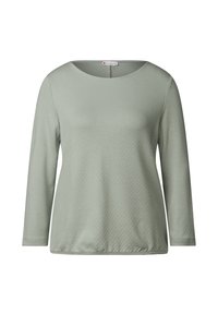 T-shirt med långa ärmar i dämpad grön, tillverkad av mjukt material med en subtil strukturerad ytfinish och rundad halsringning. Avslappnad passform, slät yta.