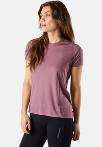 Short-sleeve, crew-neck athletic shirt in light mauve, textured material with subtle vertical stripes and logo on left shoulder.