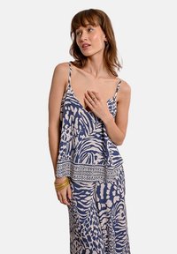 Top senza maniche blu navy e crema con una vestibilità ampia, caratterizzato da una stampa di animali della giungla e un delicato pizzo lungo l'orlo.