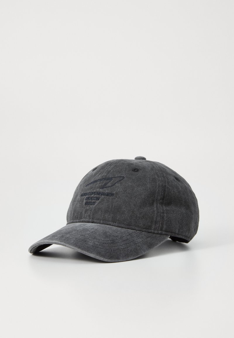 Dark gray cotton cap with a curved visor, featuring embroidered logo and text on the front. Textured finish provides a worn look.