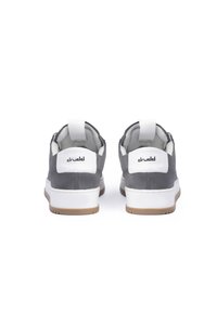 Gray suede sneakers with white accents, featuring a textured surface, a rear pull tab, and a gum rubber sole. Logo visible on the heel tab.