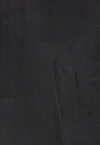 Black suede fabric with a soft, textured surface. Features a uniform color with slight variations in shade and a smooth appearance.