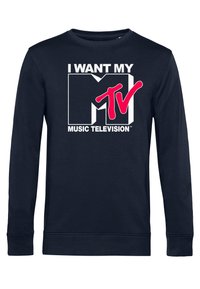 Mörkblå crewneck sweatshirt i bomull, med en stor vit och rosa grafisk tryck som säger "JAG VILL HA MIN MTV MUSIKTELEVISIONS."