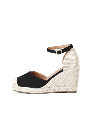 Espadrilles nere a zeppa con suola in juta intrecciata e texturizzata, cinturino alla caviglia e tacco beige con motivo. Parte superiore in tessuto liscio con lati aperti.