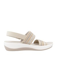 Sandalia beige y crema con tiras de textil a rayas horizontales, talón ajustable tipo slingback y suela de plataforma acolchada blanca.
