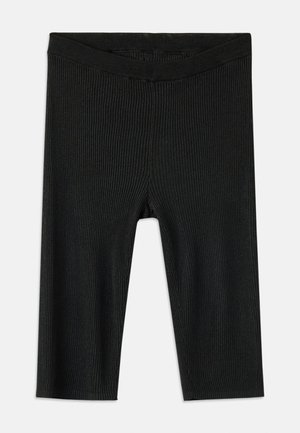 Leggings noirs côtelés avec une ceinture élastique. Le matériau a une finition texturée et le design présente une longueur mi-mollet.