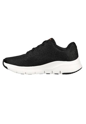 Zapatilla deportiva negra con parte superior de punto, media suela blanca, puntera redondeada y suela negra. Presenta seis ojales y tejido texturizado.