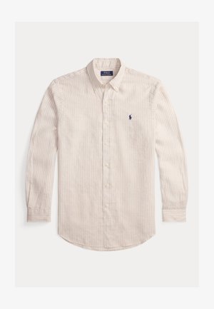 Koszula z guzikami w jasnobeżowym kolorze z cienkimi pionowymi paskami. Bawełniana tkanina, długie rękawy, zaokrąglony dół oraz małe haftowane logo w kolorze granatowym.