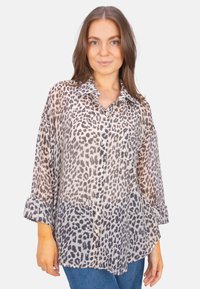 Leopard print, sheer button-up shirt with a collar, long sleeves rolled at cuffs, featuring a relaxed fit and soft texture.