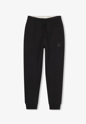 Zwarte taps toelopende joggingbroek met elastische tailleband en trekkoord, zijzakken, elastische boorden bij de enkels en een klein rond logo op de rechterdij.