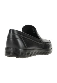 Scarpe slip-on in pelle nera con un design elegante, punta arrotondata e suola testurizzata con linee in rilievo per una maggiore aderenza. Dettagli di cucitura discreti.