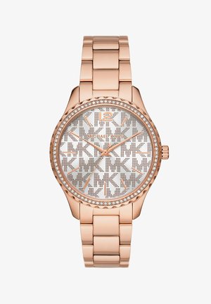 Roséguld-tonad klocka med en silverfärgad perforerad urtavla, pärlbesatt bezel och länkarmband. Har logotyp och stora siffermarkeringar vid 12.