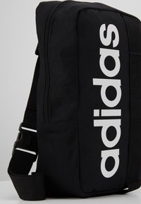 adidas Performance ESSENTIALS LINEAR SPORT CROSS BODY BAG - Umhängetasche - black/white