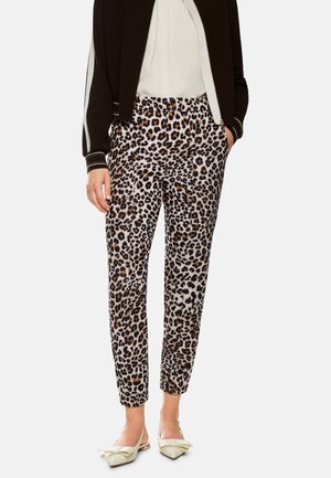 Leopard print pants made from lightweight fabric; tapered leg design with an elastic waistband; neutral tones of beige, brown, and black.