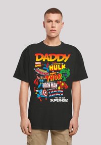 Black cotton T-shirt featuring colorful superhero graphics, including Hulk, Spider-Man, Thor, Iron Man, and Captain America, with bold text.