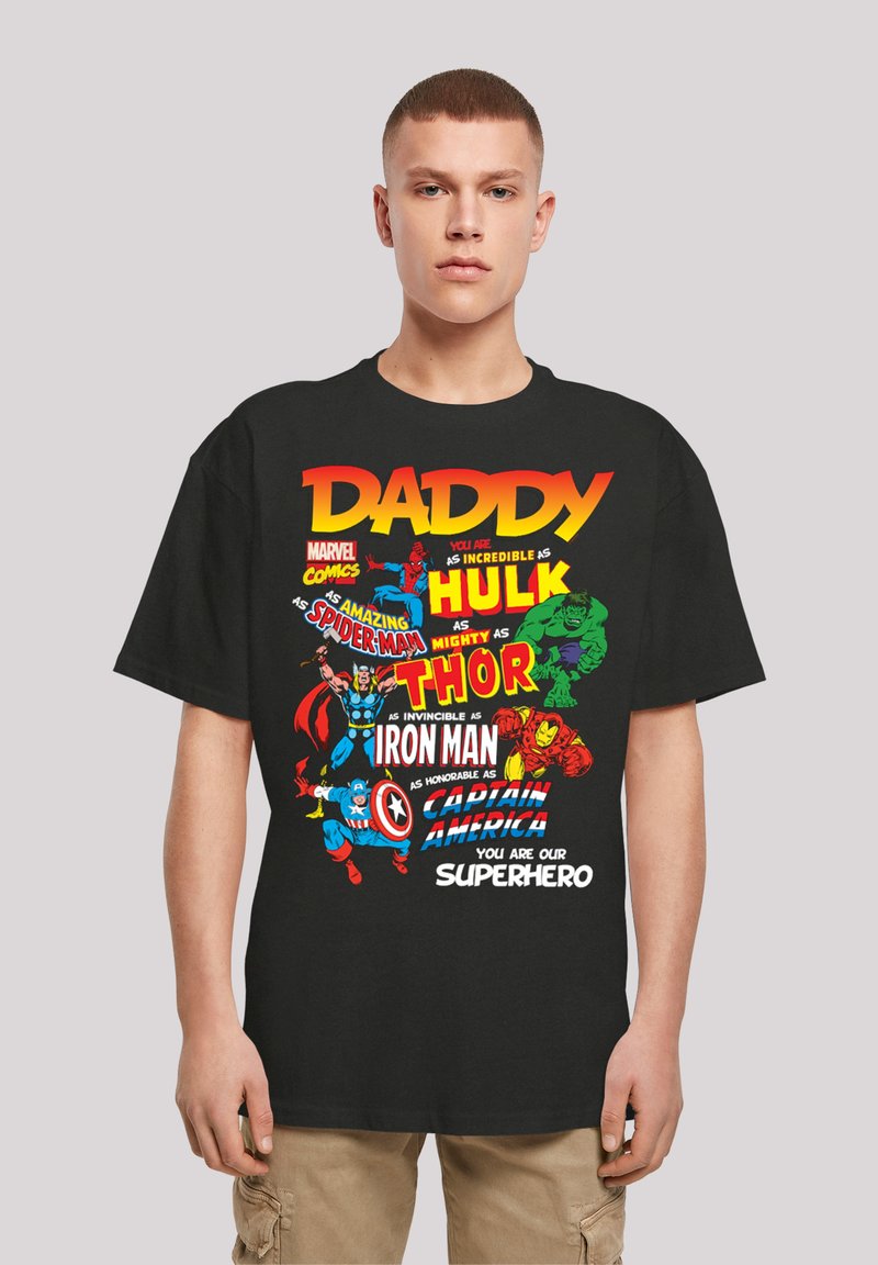 Black cotton T-shirt featuring colorful superhero graphics, including Hulk, Spider-Man, Thor, Iron Man, and Captain America, with bold text.