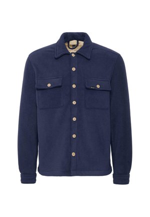 Marineblå fleece skjortejakke med to brystlommer, knaplukninger og en kremfarget foring. Har en klassisk krage og myk tekstur.