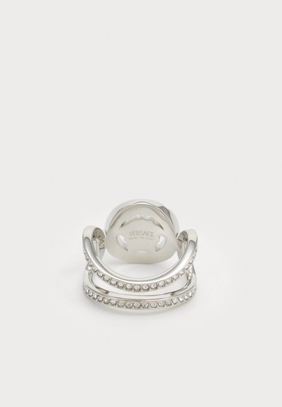 Silver multi-band ring featuring a smooth finish and inset clear crystals along one band. Engraved logo detail on the inner side.