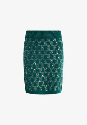Fustă tricotată teal cu un model în carouri și paiete argintii. Croi slim, cu un tiv ribbit. Textură moale și lungime până la mijlocul coapsei.