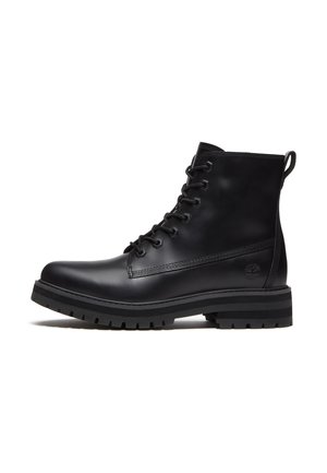 Black leather lace-up ankle boot with a thick lug sole and a pull tab at the back, side view showing a small embossed logo near the heel.