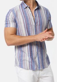 Short-sleeve button-up shirt in blue, cream, and red striped pattern; fabric has a textured weave, features navy collar and buttons.