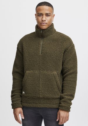 Fleece pullover in olive green, featuring a half zip, high collar, front pouch pocket, and textured, soft surface.