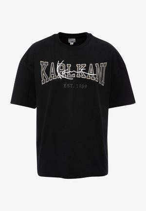 T-shirt en coton noir avec une broderie blanche audacieuse de "KARLKANI" et "EST. 1989" dans un design contrasté. Manches courtes et col rond.
