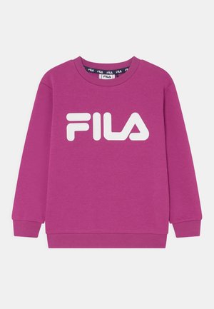 Fioletowa bluza z okrągłym dekoltem i długimi rękawami, z białym logo FILA na środku klatki piersiowej na jednolitym tle.