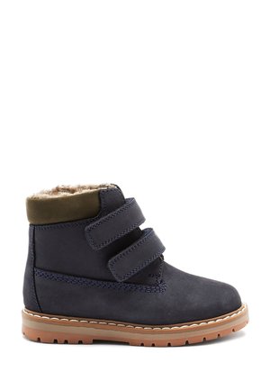 Navy blue suede boots with two Velcro straps, a brown rubber sole, and a soft, faux fur lining at the top for warmth and comfort.