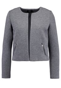 Chaqueta gris texturizada con cuello redondo, mangas largas y cremalleras laterales, que presenta un diseño de tela acanalada y un cierre frontal abierto.