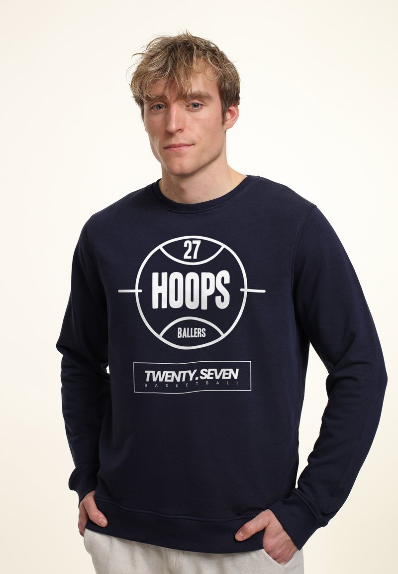 Marinblå sweatshirt i bomull med en stor vit basketgrafik som har texten "HOOPS" och "TWENTY.SEVEN". Ribbad halsringning och muddar.