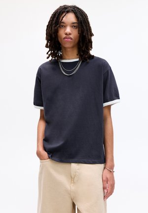 Navy blue short-sleeve t-shirt with white trim at the collar and sleeves, made of soft fabric, with a relaxed fit and minimal design.